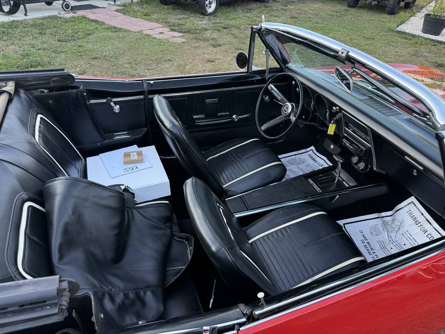 Black interior of a 1967 Camaro SS convertible with the SS steering wheel